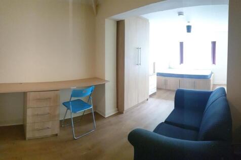 Spacious master bedroom with desk and sofa...