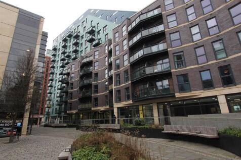 Modern apartment complex with outdoor seating....