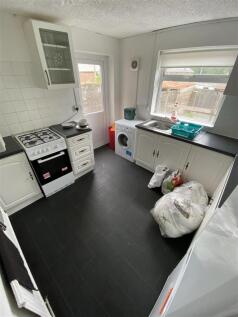 Bright kitchen with modern dark flooring...