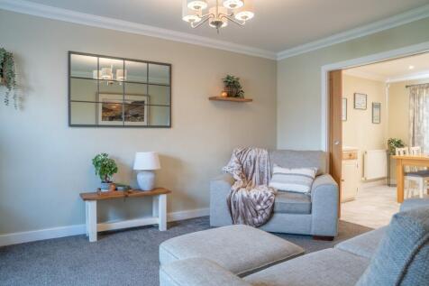 Lounge With Sliding Oak Doors To Kitchen Diner