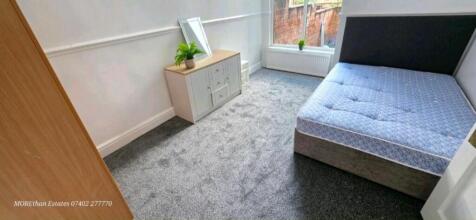 Bright double bedroom with modern grey carpet...