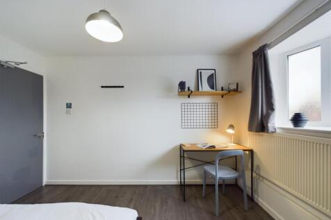 A bright and cozy bedroom featuring natural lig...