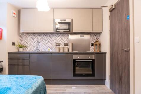 Modern kitchenette with glossy grey lower cabin...