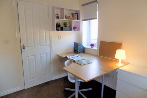 Bright, tidy study corner with a large wooden d...
