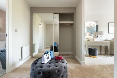 A dedicated dressing area in bedroom 1 boasts space for storage
