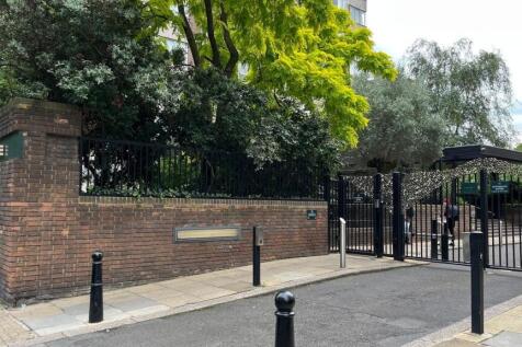 Secure gated entrance with lush greenery...