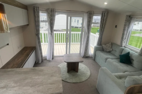 Bright open plan lounge with patio doors in Willer