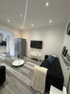 Modern and inviting living room featuring a sle...