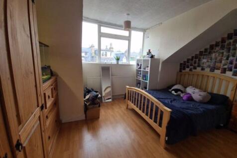 Bright double bedroom featuring a large window ...