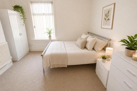 Bright and airy bedroom with stylish decor and ...