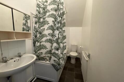 Bright bathroom with bath and stylish curtain...