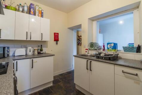 Bright kitchen with modern white cabinetry...