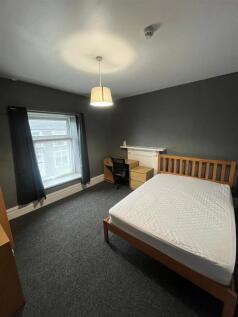 Spacious modern bedroom with a large study desk...