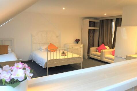 A bright and tidy double bedroom featuring two ...