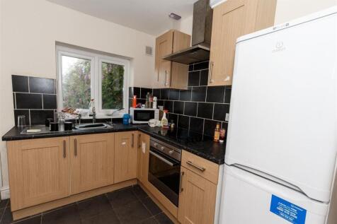 Modern kitchen with sleek black tile splashback...