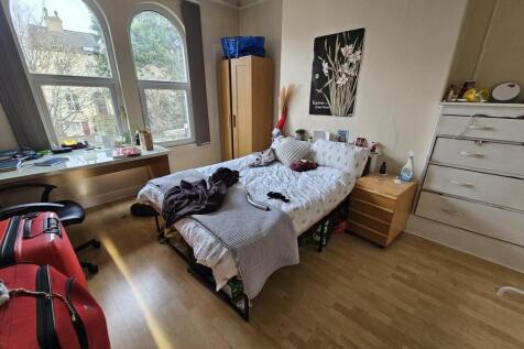Bright double bedroom with large arched windows...
