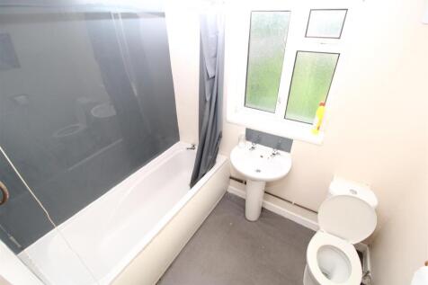 Bright bathroom with a full-sized bathtub...