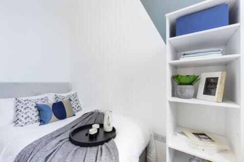 A stylish and inviting double bedroom with mode...