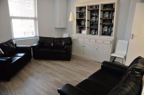 A spacious and modern living room with large wi...
