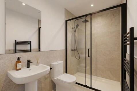 Sleek modern bathroom with rainfall shower...