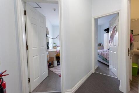 Bright, clean hallway leading to bedrooms...