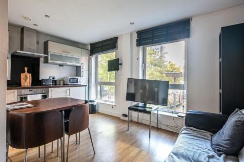 Bright open-plan living area with large windows...
