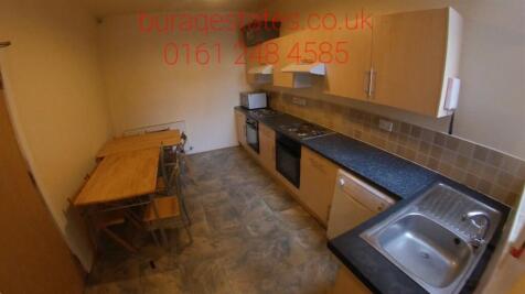 Long galley kitchen with fitted cabinets, full-...