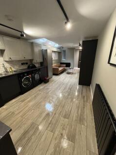 Modern open-plan living area with a fitted kitc...
