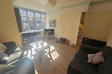 A bright and welcoming living room with ample n...