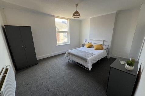 Bright and airy double bedroom featuring a comf...