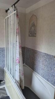 Bright bathroom with a full-sized bathtub...
