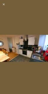 Bright, modern kitchen with integrated oven and...