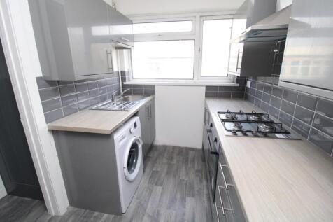 Modern galley kitchen with sleek grey cabinets...