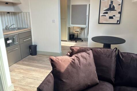 Bright modern living area with dedicated desk...