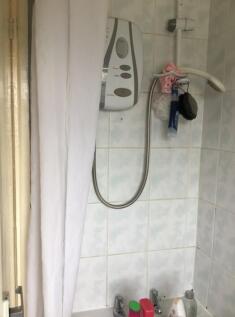 Bathroom with bath and overhead shower