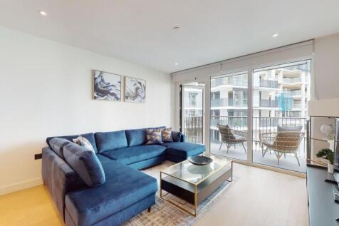 Bright modern lounge with large navy sectional...