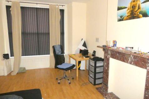 Bright, tidy bedroom with desk and seating...