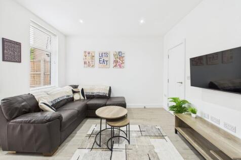 Bright and modern living room featuring a comfo...