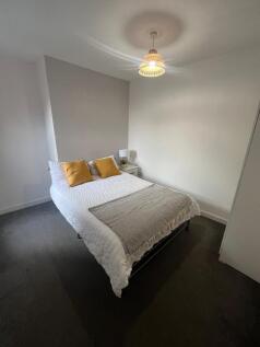 A spacious and inviting bedroom featuring a com...