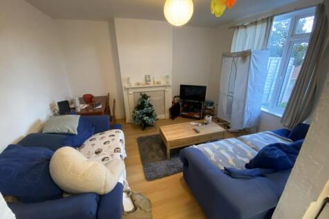 Bright, well-furnished living room with two com...