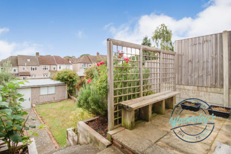Patio area with substantial garage to rear