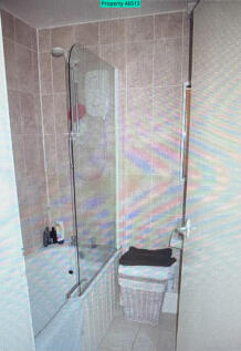 Fully tiled large bathroom as toilet is separate.