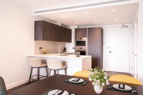 Experience the elegance of a contemporary kitchen paired with a chic dining space.