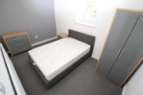 Modern double bedroom with sleek grey furniture...