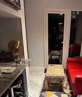 Cosy lounge area with red sofa and stylish deco...