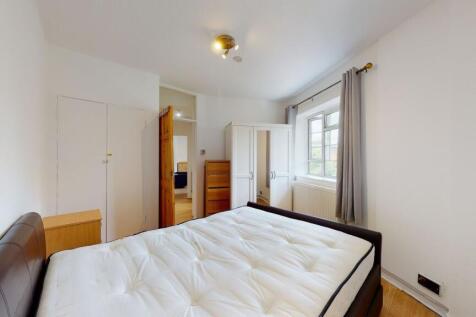 Bright bedroom with ample storage and natural l...