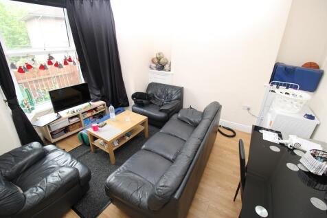 Bright living room with ample leather seating...