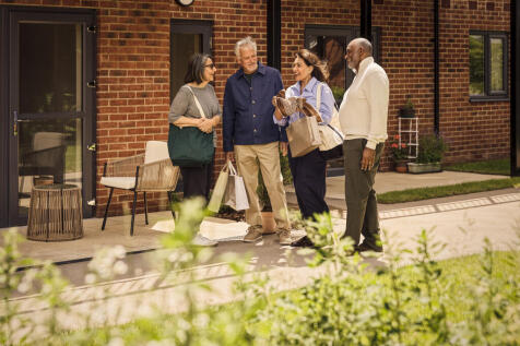 a group of people standing outside a brick building