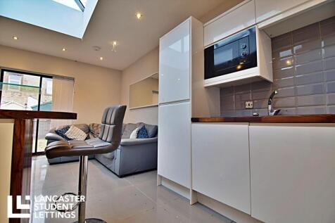 Modern kitchen with skylight and breakfast bar...