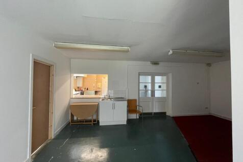 A simple communal lounge area featuring a small...